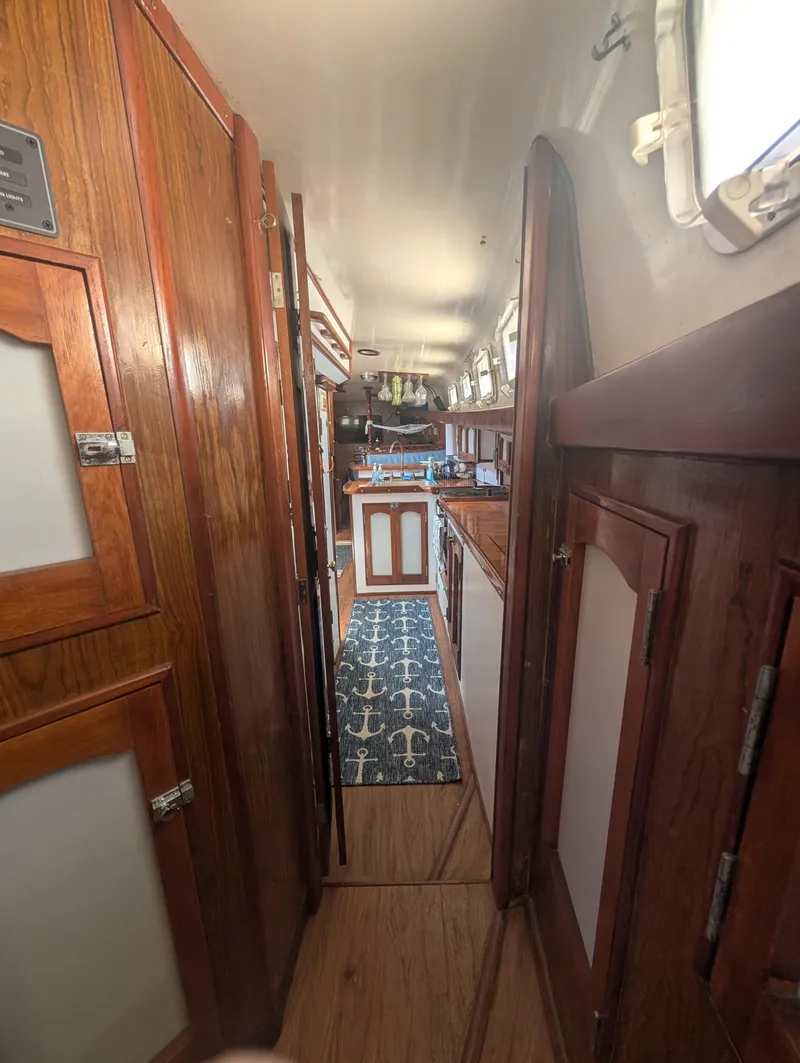 Slide: The Image of Interior of 1976 Mason COHORT II yacht with wooden cabinetry and nautical-themed decor. - 5