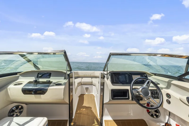 Slide: The Image of 2019 Regal LS4 boat interior with steering wheel, dashboard, and ocean view. - 12