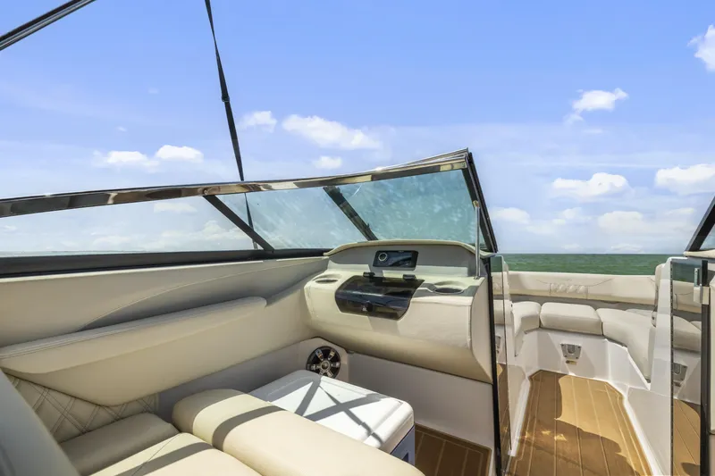 Slide: The Image of 2019 Regal LS4 boat interior with luxurious seating and clear sky view. - 13
