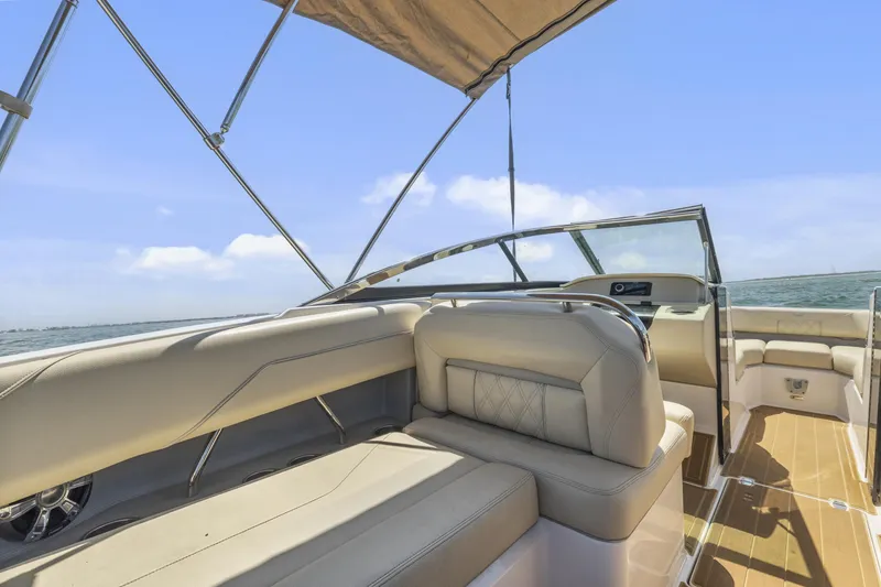 Slide: The Image of 2019 Regal LS4 boat interior with beige seating, canopy, and ocean view. - 17