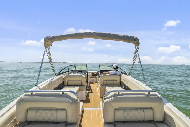 Slide: The Image of 2019 Regal LS4 boat cruising on open water under clear blue skies. - 19