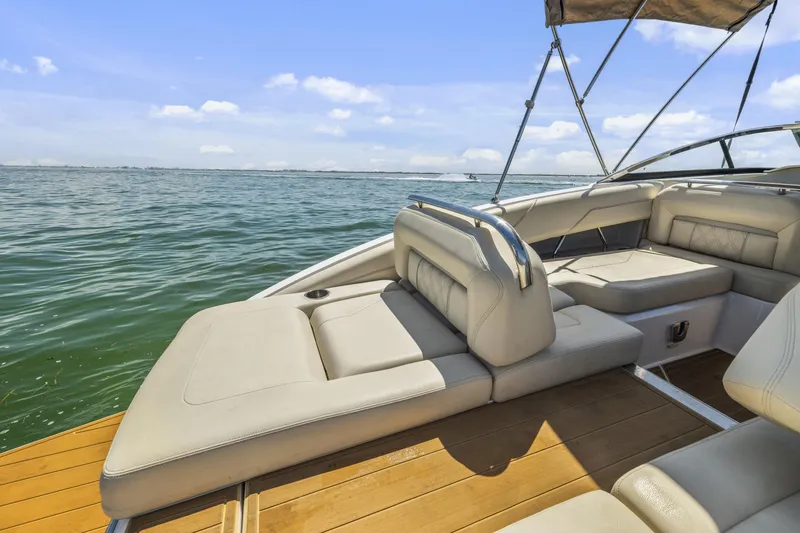 Slide: The Image of 2019 Regal LS4 boat interior with luxurious seating on a sunny day at sea. - 22