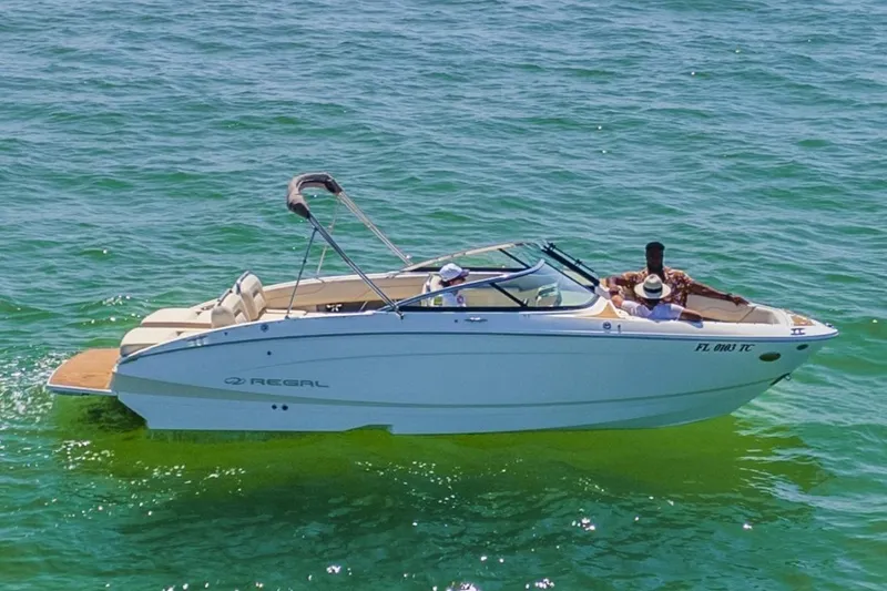Slide: The Image of 2019 Regal LS4 boat cruising on clear blue water with passengers onboard. - 3