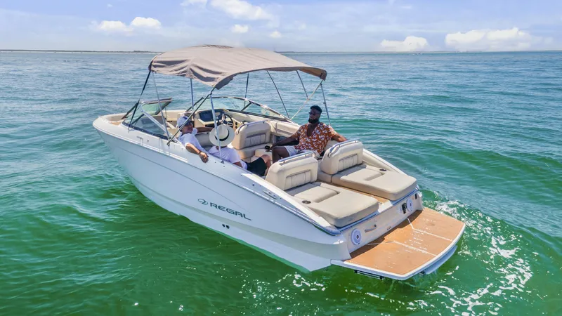 Slide: The Image of 2019 Regal LS4 boat cruising on open water with passengers enjoying the ride. - 4