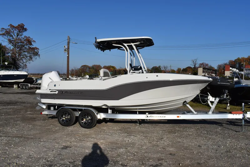 Slide: The Image of 2024 Finseeker 230 CC boat on trailer, parked outdoors under clear blue sky. - 1