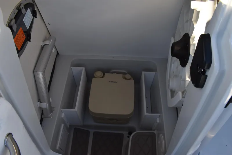 Slide: The Image of 2024 Finseeker 230 CC boat interior storage compartment with portable toilet. - 10