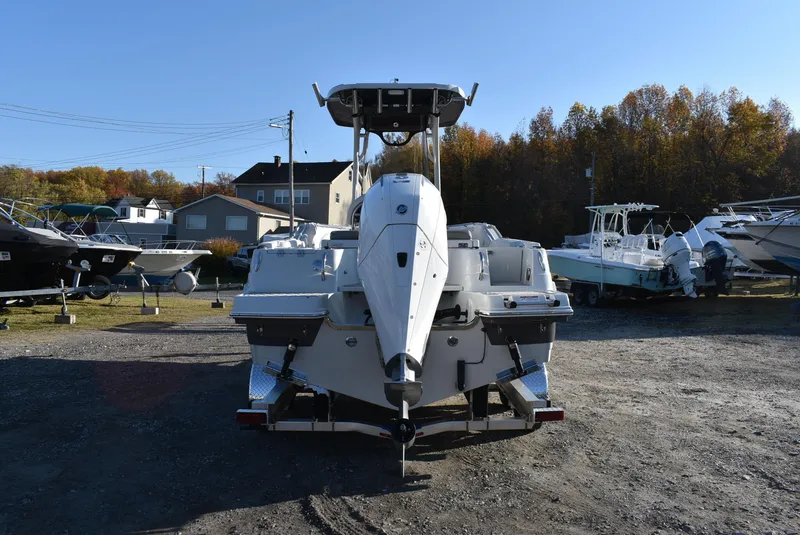 Slide: The Image of 2024 Finseeker 230 CC boat displayed outdoors, surrounded by other boats. - 11