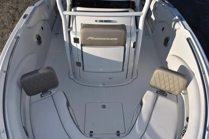 Slide: The Image of 2024 Finseeker 230 CC boat interior with cushioned seating and storage compartments. - 9