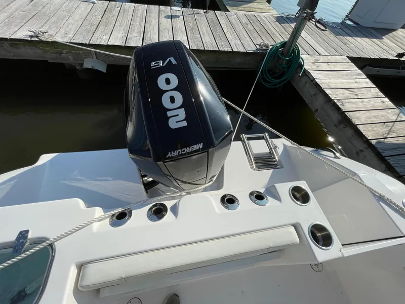 Slide: The Image of 2024 Aquasport 2200 Center Console with Mercury 200 V6 engine at dock. - 2