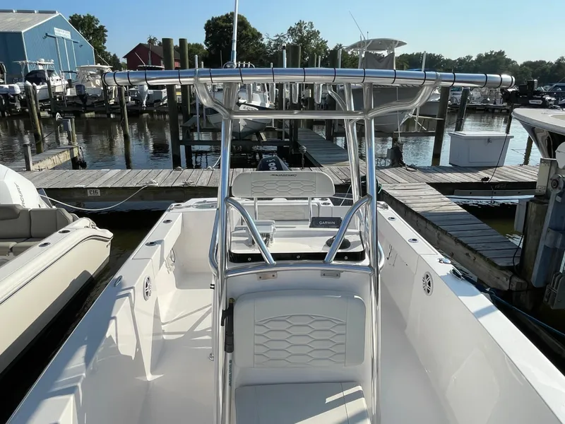 Slide: The Image of 2024 Aquasport 2200 Center Console boat docked at marina, showcasing sleek design. - 3