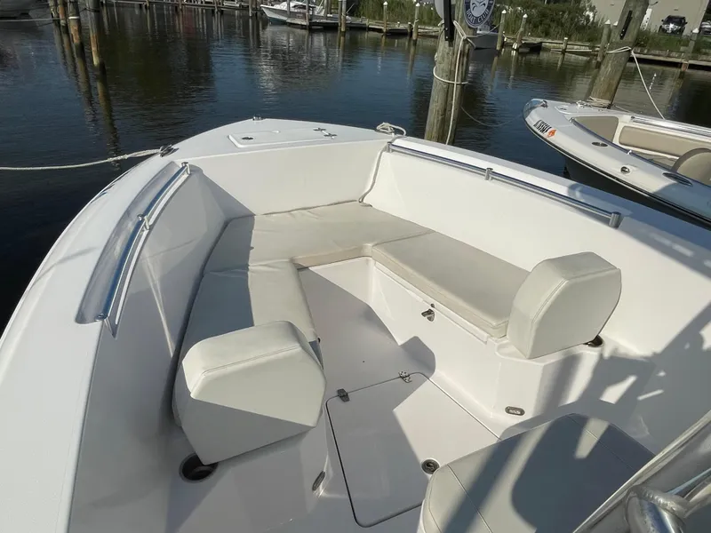 Slide: The Image of 2024 Aquasport 2200 Center Console boat with spacious seating at the dock. - 4