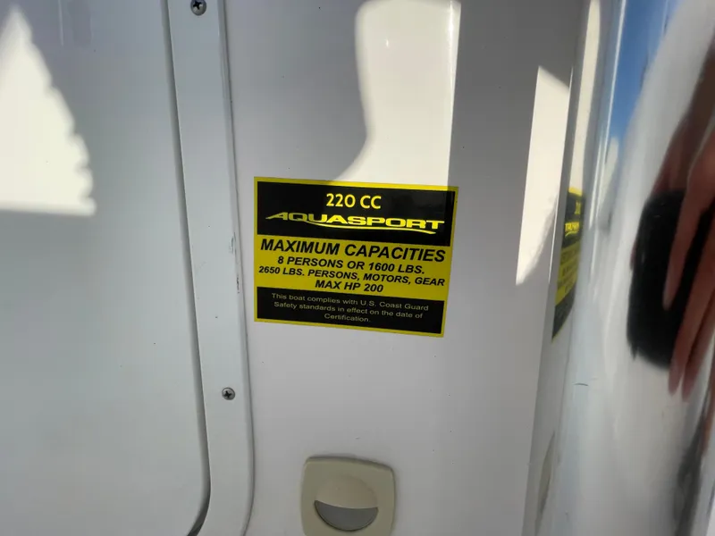 Slide: The Image of 2024 Aquasport 2200 Center Console capacity label, detailing weight and passenger limits. - 5
