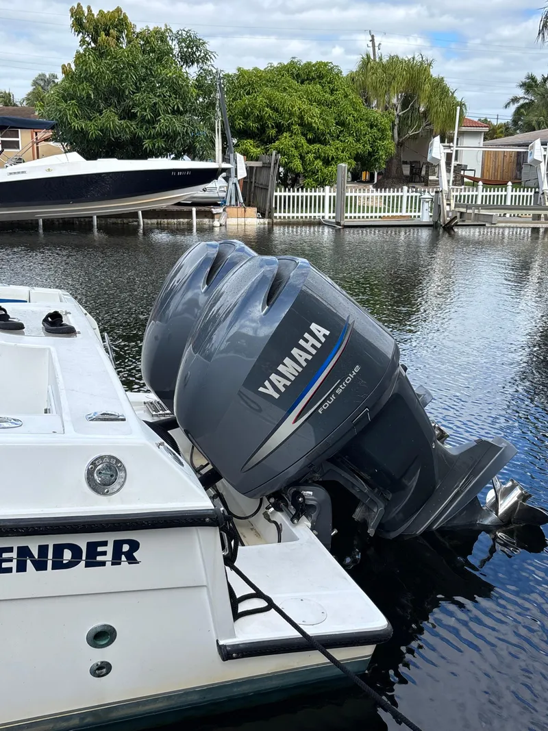 Slide: The Image of Contender 35 Side Console boat with Yamaha outboard engines docked in a canal. - 3