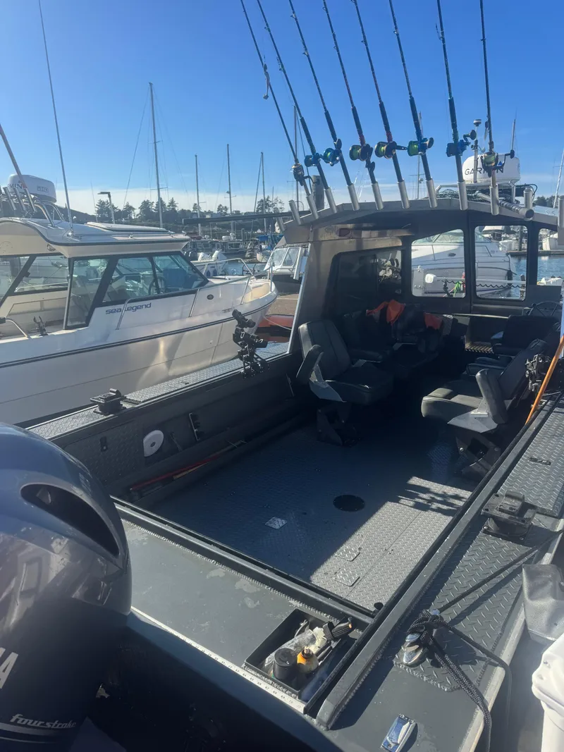 Slide: The Image of 2022 Custom Umpqua Marina 26 Bay Series boat with fishing rods, docked in marina. - 5