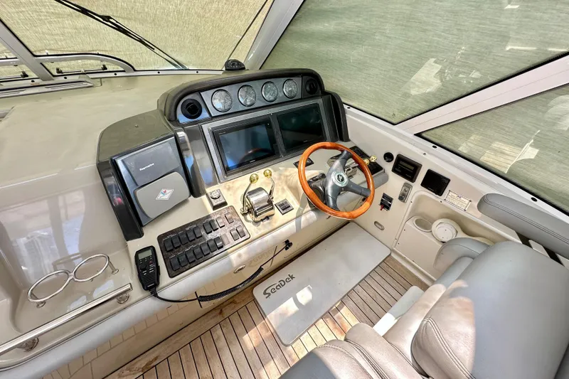 Slide: The Image of 2005 Sea Ray 48 Sundancer helm with steering wheel, controls, and navigation equipment. - 12