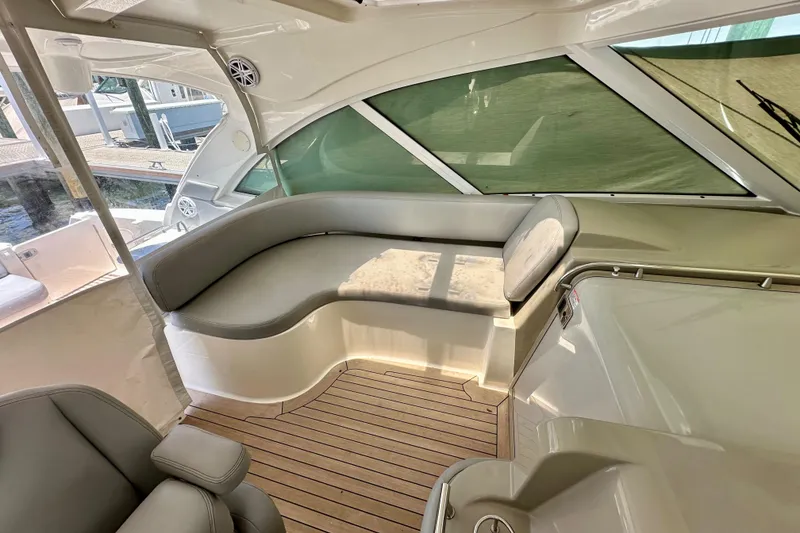 Slide: The Image of 2005 Sea Ray 48 Sundancer interior with sleek seating and wooden flooring. - 14
