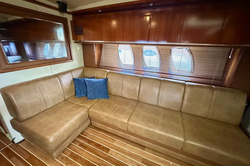 Slide: The Image of Luxurious interior of 2005 Sea Ray 48 Sundancer yacht with leather seating and wooden accents. - 19