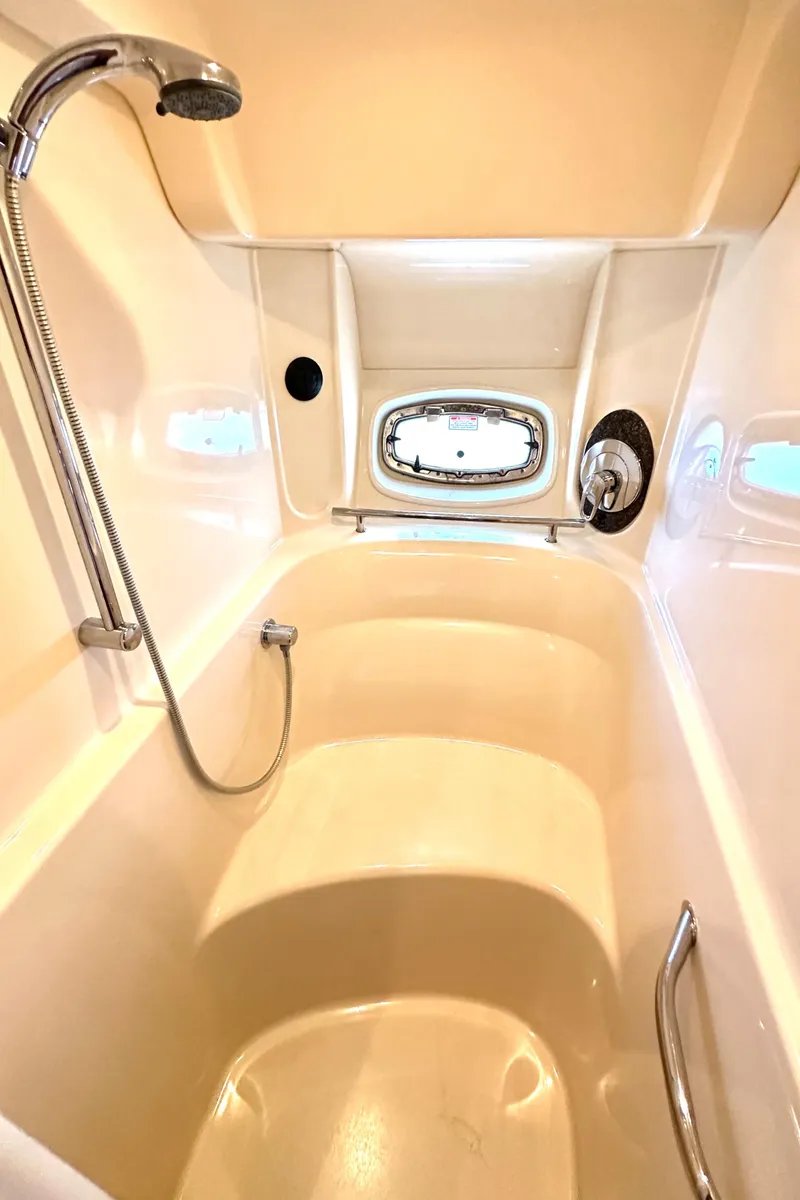 Slide: The Image of Luxurious shower area in 2005 Sea Ray 48 Sundancer yacht with porthole window. - 21