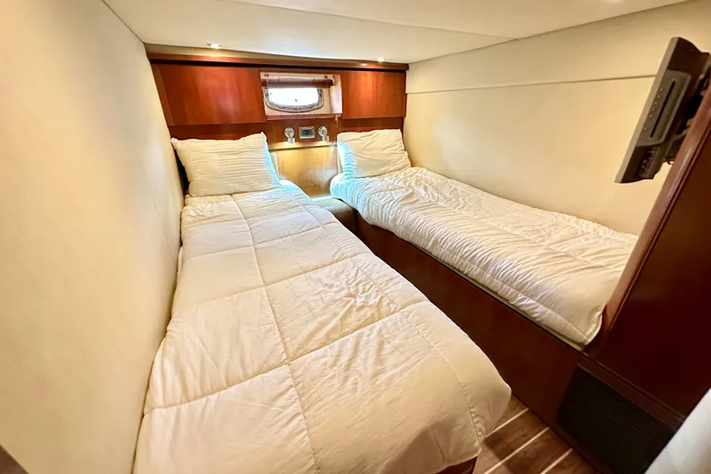 Slide: The Image of Twin cabin interior of 2005 Sea Ray 48 Sundancer yacht with cozy bedding. - 23