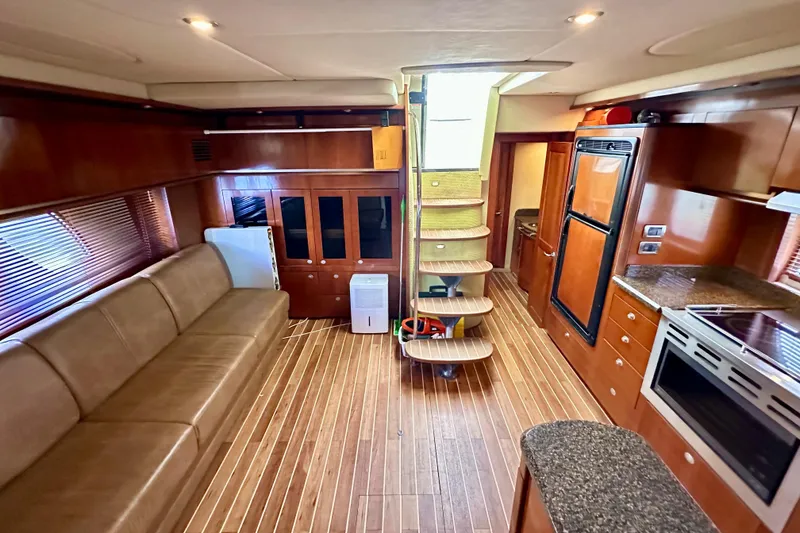 Slide: The Image of Luxurious interior of 2005 Sea Ray 48 Sundancer yacht with modern kitchen and seating area. - 26