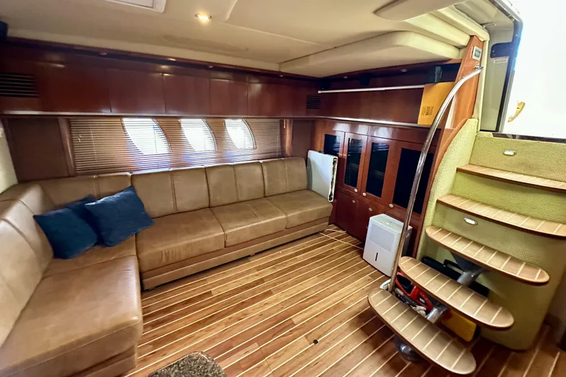 Slide: The Image of Luxurious interior of 2005 Sea Ray 48 Sundancer yacht with leather seating and wooden flooring. - 27