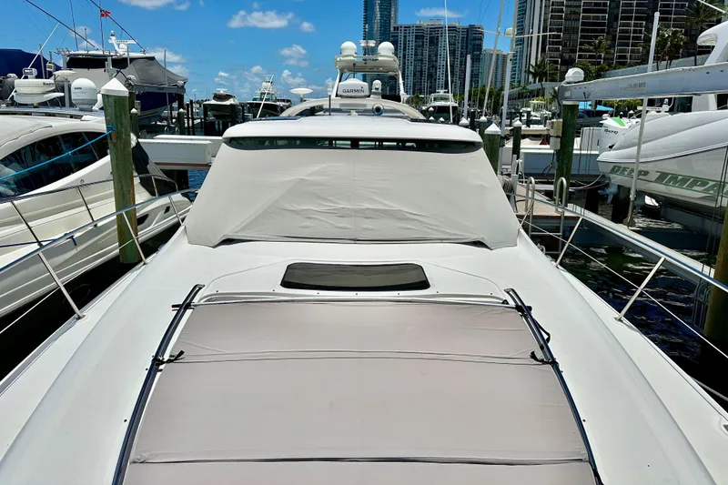 Slide: The Image of 2005 Sea Ray 48 Sundancer yacht docked at marina under clear blue sky. - 29