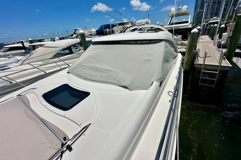 Slide: The Image of 2005 Sea Ray 48 Sundancer yacht docked at marina under clear blue sky. - 30