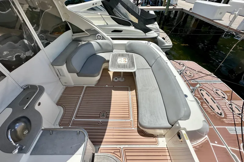 Slide: The Image of 2005 Sea Ray 48 Sundancer yacht interior with seating and table, docked at marina. - 8
