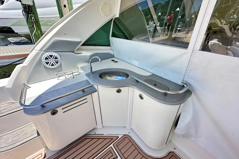 Slide: The Image of 2005 Sea Ray 48 Sundancer yacht kitchenette with sink and speaker. - 9