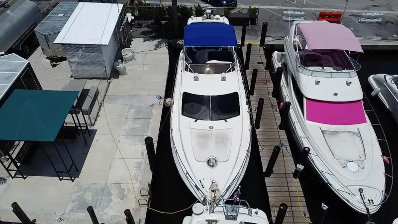 Slide: The Image of Overhead view of a 2000 Azimut 46 yacht docked between two other boats. - 10