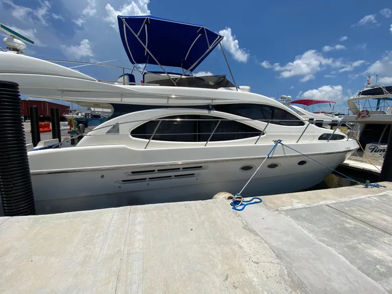 Slide: The Image of Azimut 46 yacht from 2000 docked at marina under clear blue sky. - 13