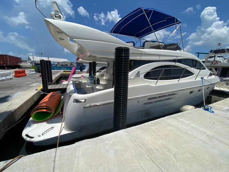 Slide: The Image of Azimut 46 yacht from 2000 docked at marina under clear blue sky. - 18