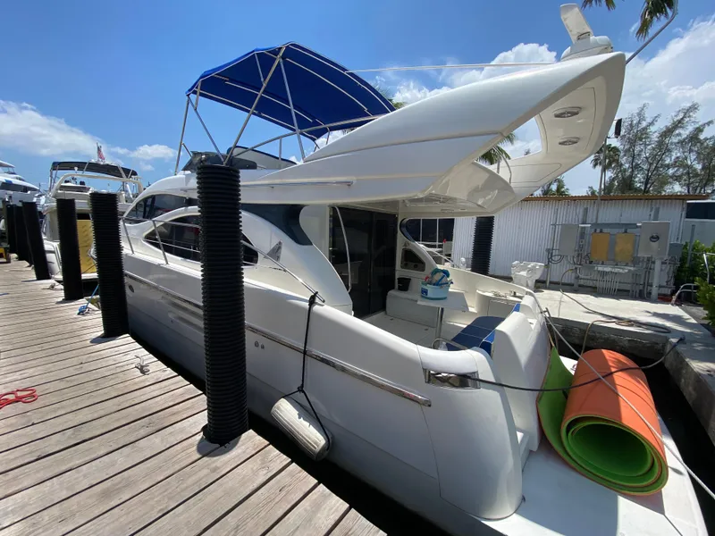 Slide: The Image of Luxury Azimut 46 yacht from 2000 docked under a clear blue sky. - 19