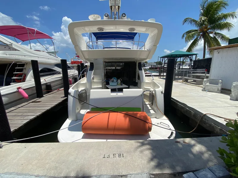 Slide: The Image of Azimut 46 yacht docked at marina, sunny day, palm tree in background. - 20