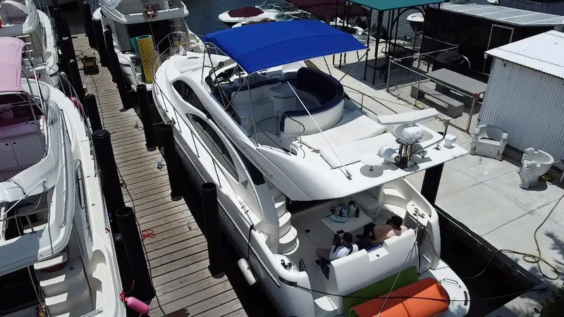 Slide: The Image of Azimut 46 yacht from 2000 docked at marina with blue canopy. - 21