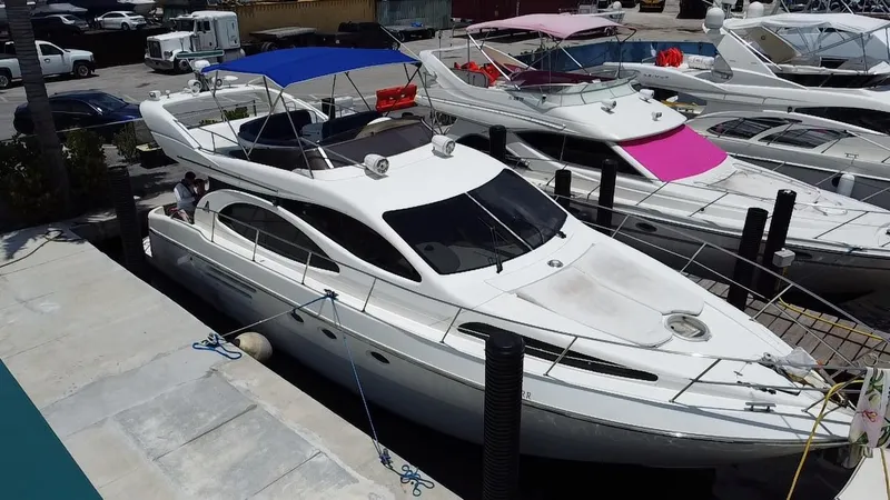 Slide: The Image of Azimut 46 yacht from 2000 docked at a marina with other boats. - 25
