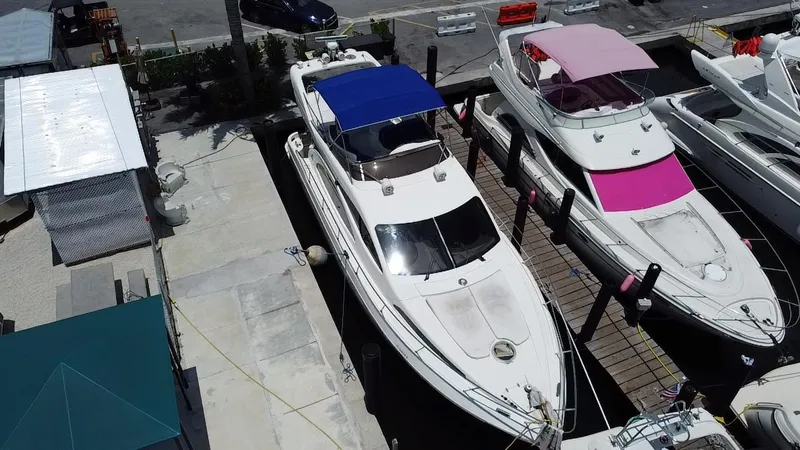 Slide: The Image of Azimut 46 yacht from 2000 docked alongside other boats at a marina. - 26