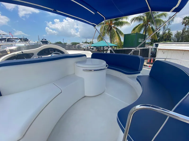 Slide: The Image of Azimut 46 yacht interior, 2000 model, featuring blue and white seating under a canopy. - 28