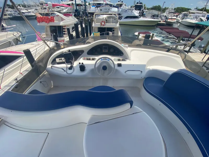 Slide: The Image of Cockpit of 2000 Azimut 46 yacht with blue seating and control panel. - 29