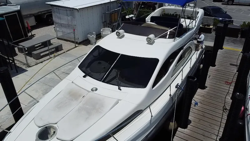 Slide: The Image of Azimut 46 yacht from 2000 docked at a marina, featuring a sleek white design. - 3