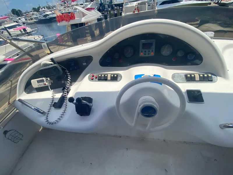 Slide: The Image of Helm of 2000 Azimut 46 yacht with steering wheel and control panel. - 30