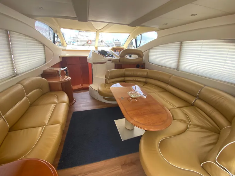 Slide: The Image of Luxurious interior of a 2000 Azimut 46 yacht with leather seating and wooden table. - 31