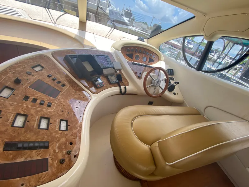 Slide: The Image of Luxurious helm of a 2000 Azimut 46 yacht with leather seating and wood accents. - 32