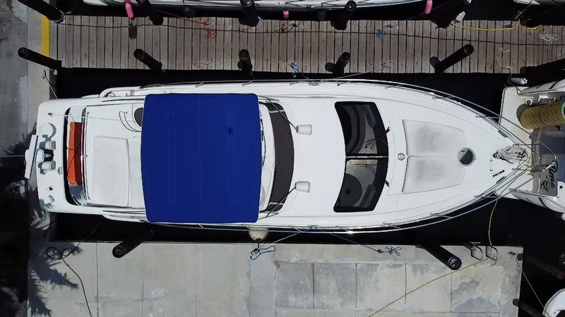 Slide: The Image of Overhead view of a 2000 Azimut 46 yacht docked, featuring a blue canopy. - 34