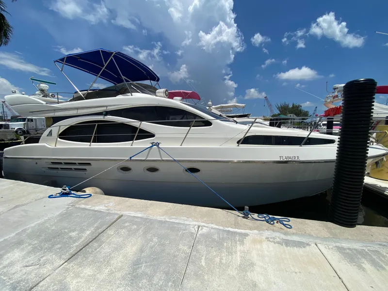 Slide: The Image of Azimut 46 yacht from 2000 docked under a blue sky. - 35