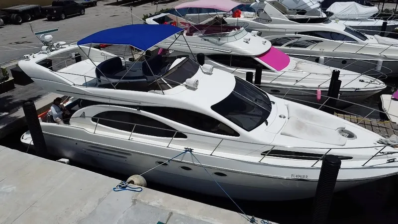 Slide: The Image of Azimut 46 yacht from 2000 docked at a marina with other boats. - 4