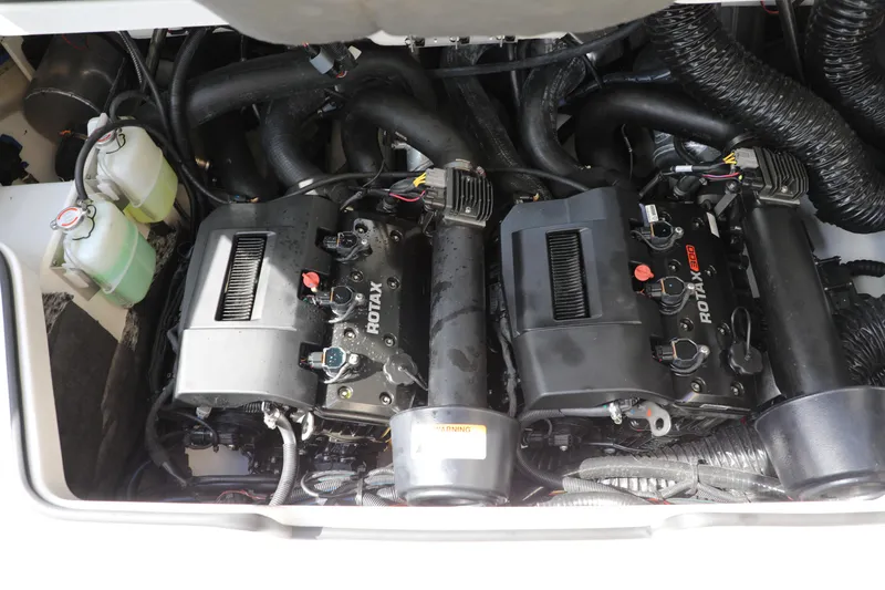 Slide: The Image of Engine compartment of 2023 Scarab 255 ID boat featuring dual Rotax engines. - 13