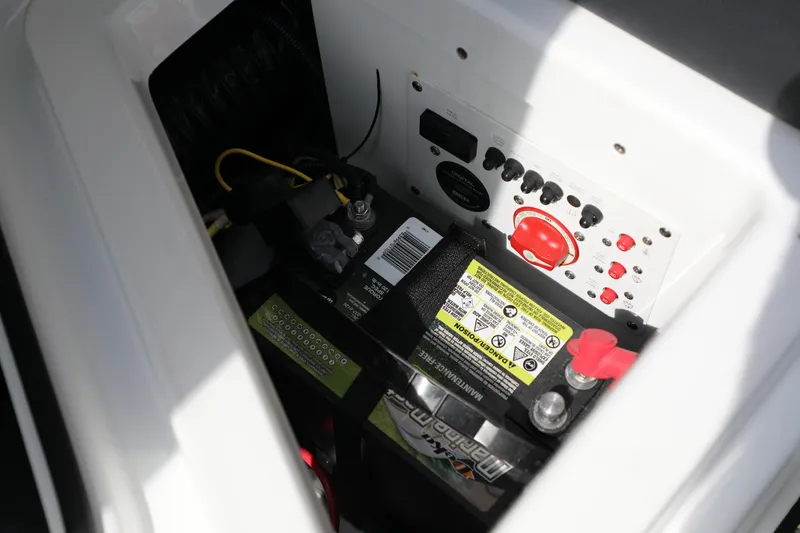 Slide: The Image of 2023 Scarab 255 ID boat battery compartment with control panel and wiring. - 14