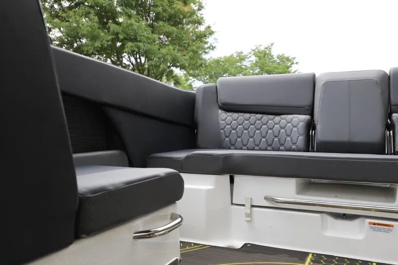 Slide: The Image of 2023 Scarab 255 ID boat interior with sleek black seating and modern design. - 15