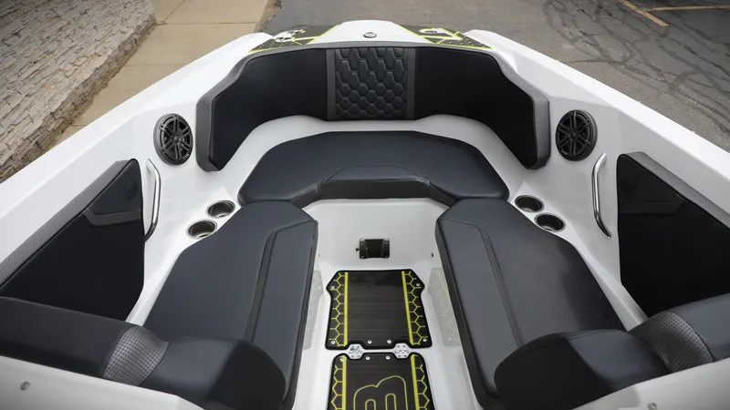 Slide: The Image of 2023 Scarab 255 ID boat interior with black seating and cup holders. - 4